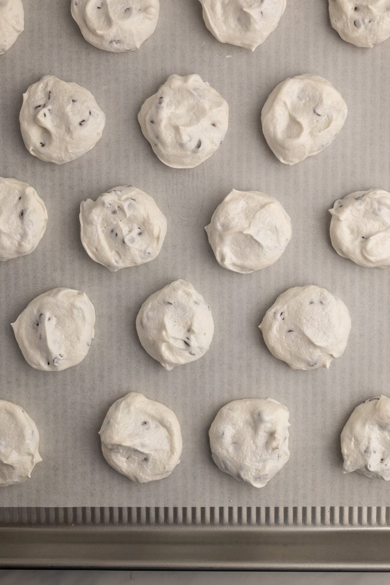 chocolate chip meringues on a sheet pan